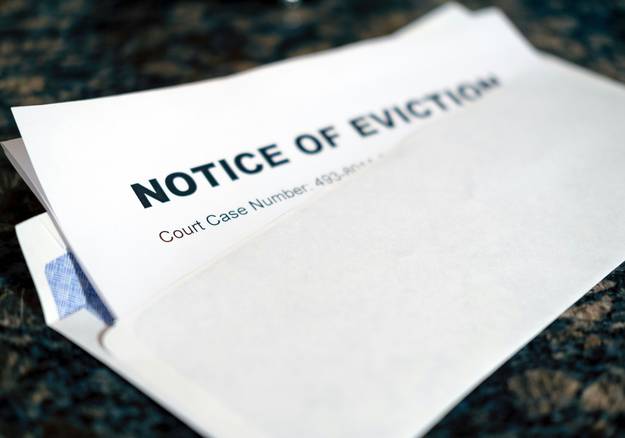 Arizona residential property with landlord and tenant reviewing eviction notice paperwork