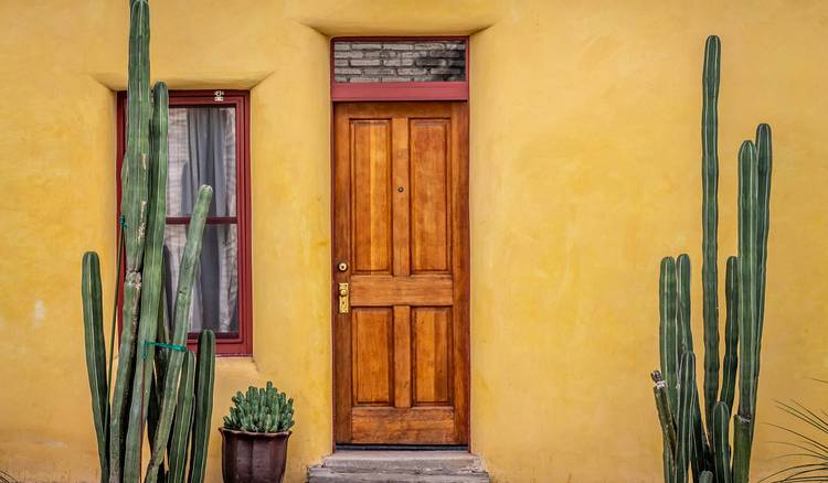 Arizona landlord giving notice before entering rental property, with a clear view of an apartment door in desert environment