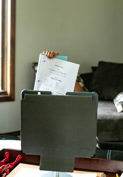 Arizona landlord reviewing rental agreement and notice paperwork at a desk