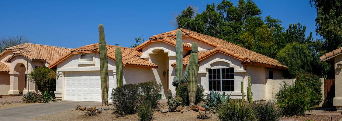Arizona landlord and tenant meeting to review a rental agreement in a sunlit Arizona home || landlord tenant handshake || Arizona rental paperwork #|#Landlord and tenant reviewing an Arizona rental lease agreement#|#arizona-landlord-tenant-faqs-hero.jpg
