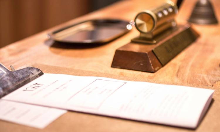 A closeup of a rental notice letter on a desk with Arizona lease paperwork and apartment keys