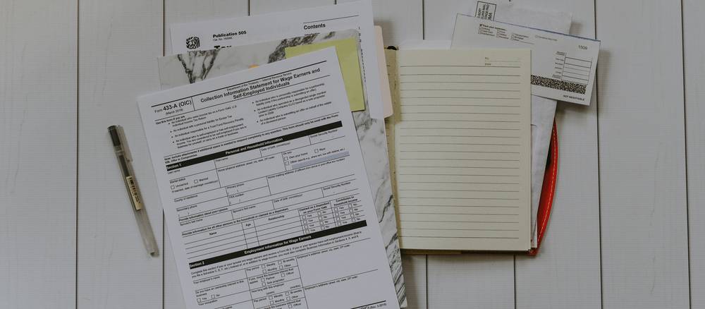 Arizona rental property paperwork and application forms on a desk with pen and clipboard